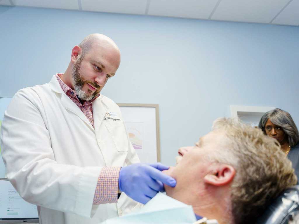 Dentist examines a patient's mouth ensuring only the best dental care for cosmetic dentistry.