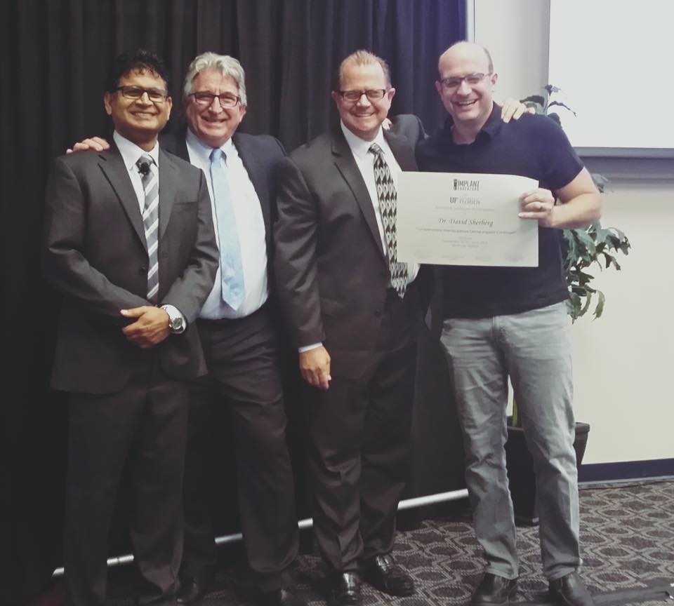 Dr. Sherberg receiving certification in Same Day Teeth, All-on-4 Dental Implants at University of Florida.